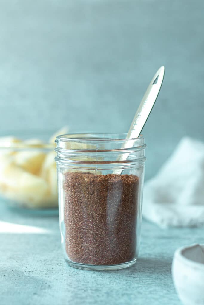 house seasoning mix in small jar with teaspoon