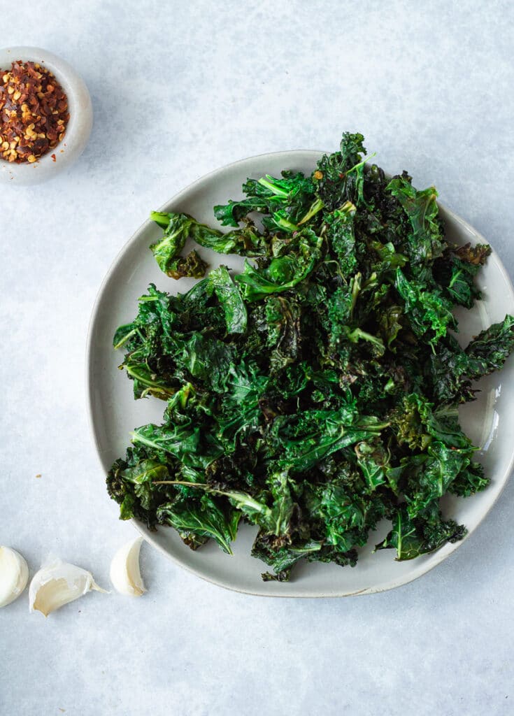 sautéed kale on plate with garlic and red pepper flakes