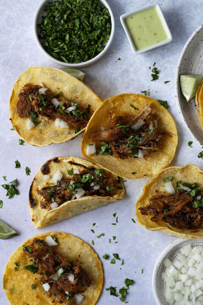 crispy carnitas on tacos with cilantro and onions