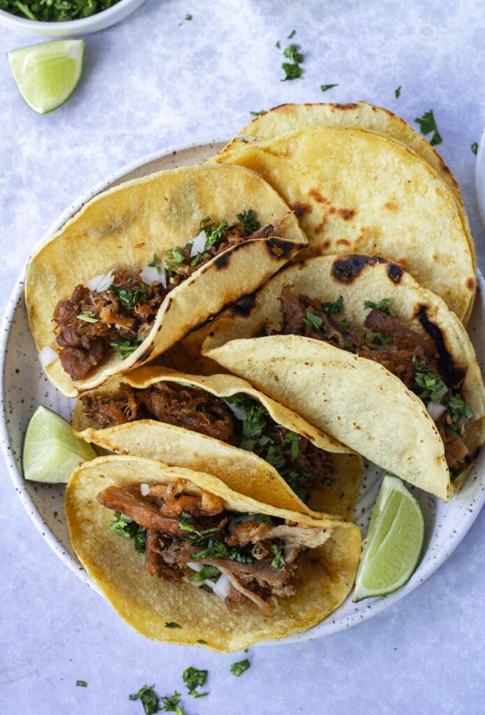 crispy carnitas tacos with toppings on plate