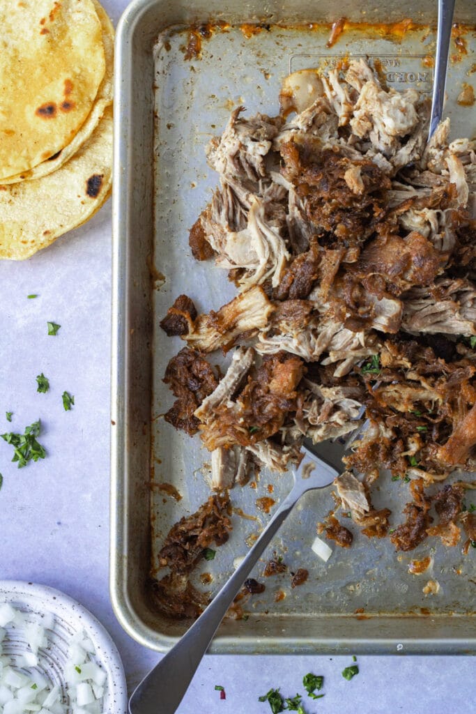 Crispy carnitas on baking sheet