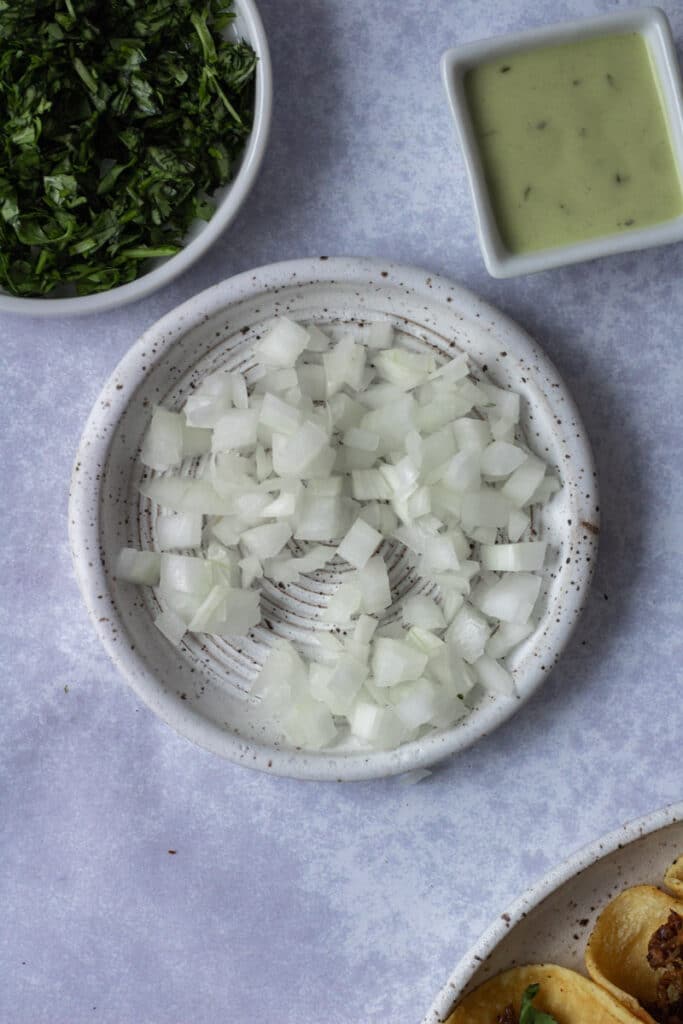 chopped onions and cilantro on small plates