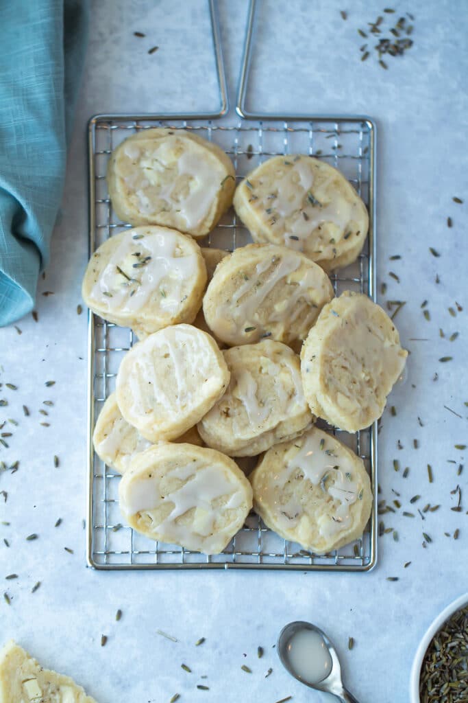 Pile of lavender white chocolate shortbread cookies on cooling rack