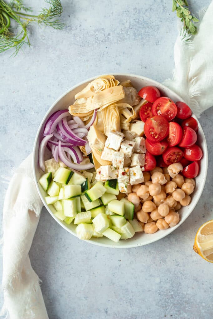 separate ingredients for greek salad on small plate