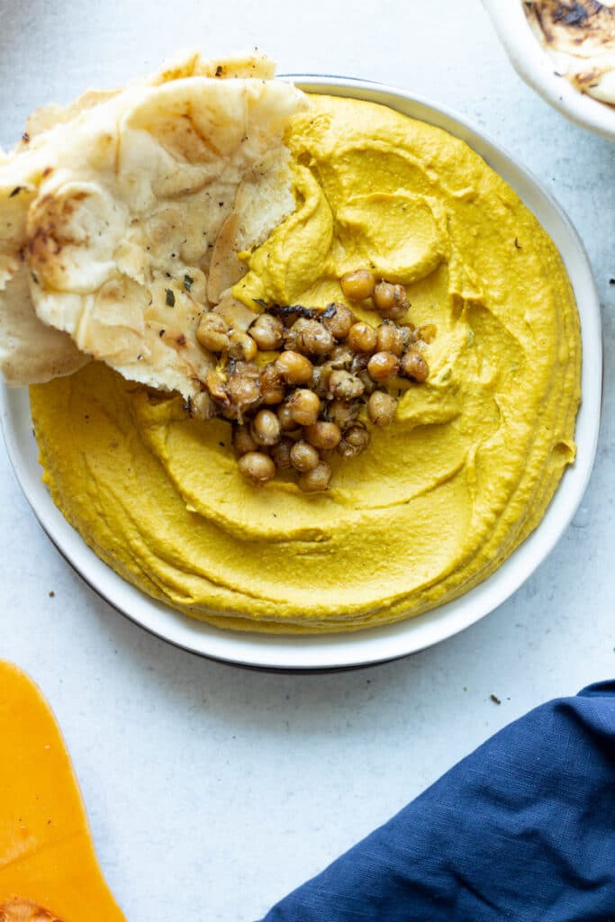 hummus with chickpeas and naan on plate