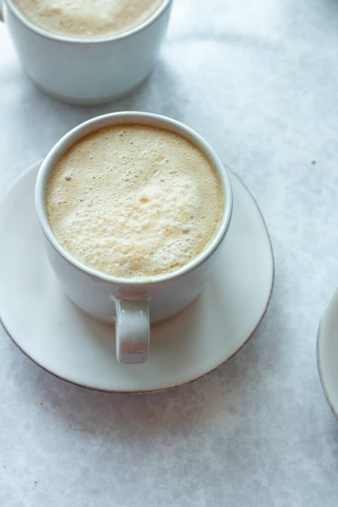 close up of pumpkin coffee in mug on small plate