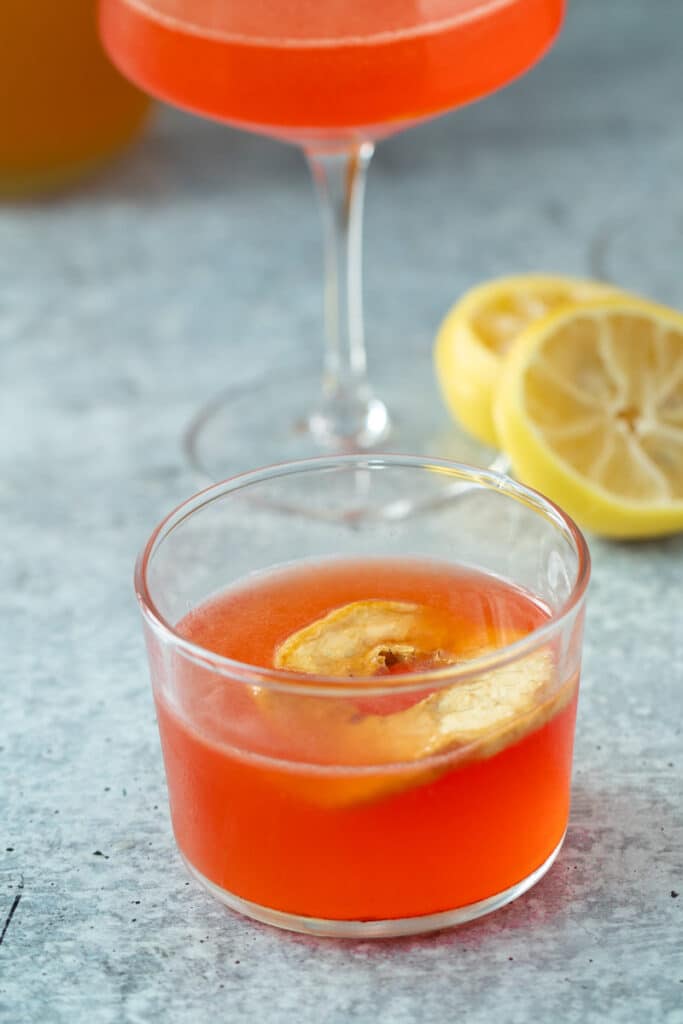 apple cider cocktail in short glass with dried apple