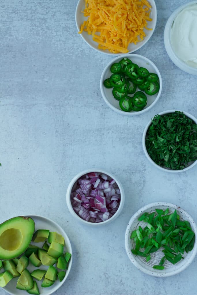 Chili toppings in separate small bowls.