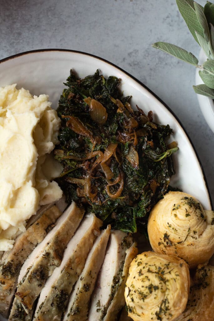 kale and caramelized onions on platter with Thanksgiving meal