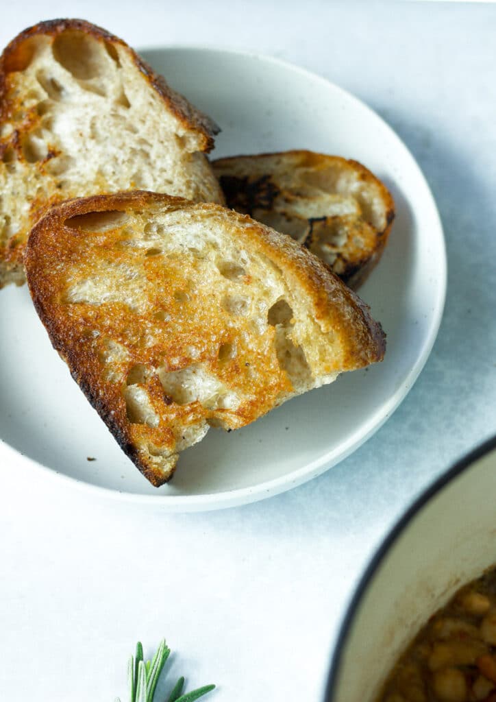 plate with three pieces of olive oil toast