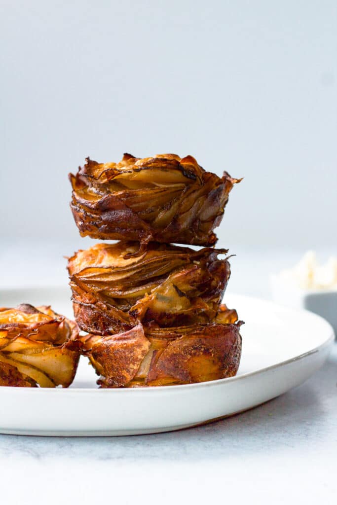 Three potato stacks on plate with garlic mayo