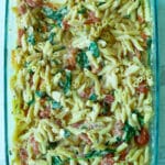 tomato and feta pasta mixed in glass baking dish
