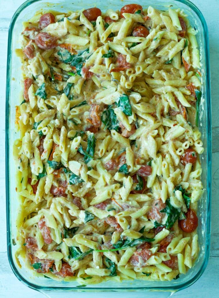 tomato and feta pasta mixed in glass baking dish