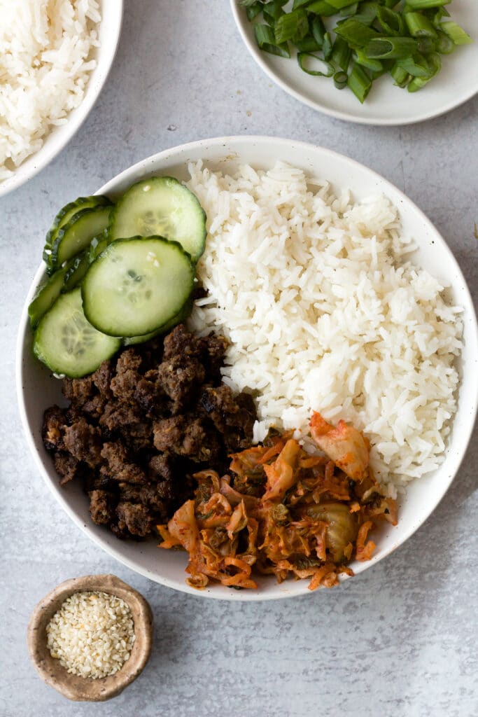 ground beef bulgogi bowl with small bowl of sesame seeds next to it