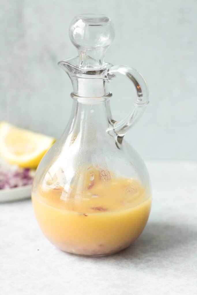 Lemon garlic vinaigrette in glass salad dressing bottle