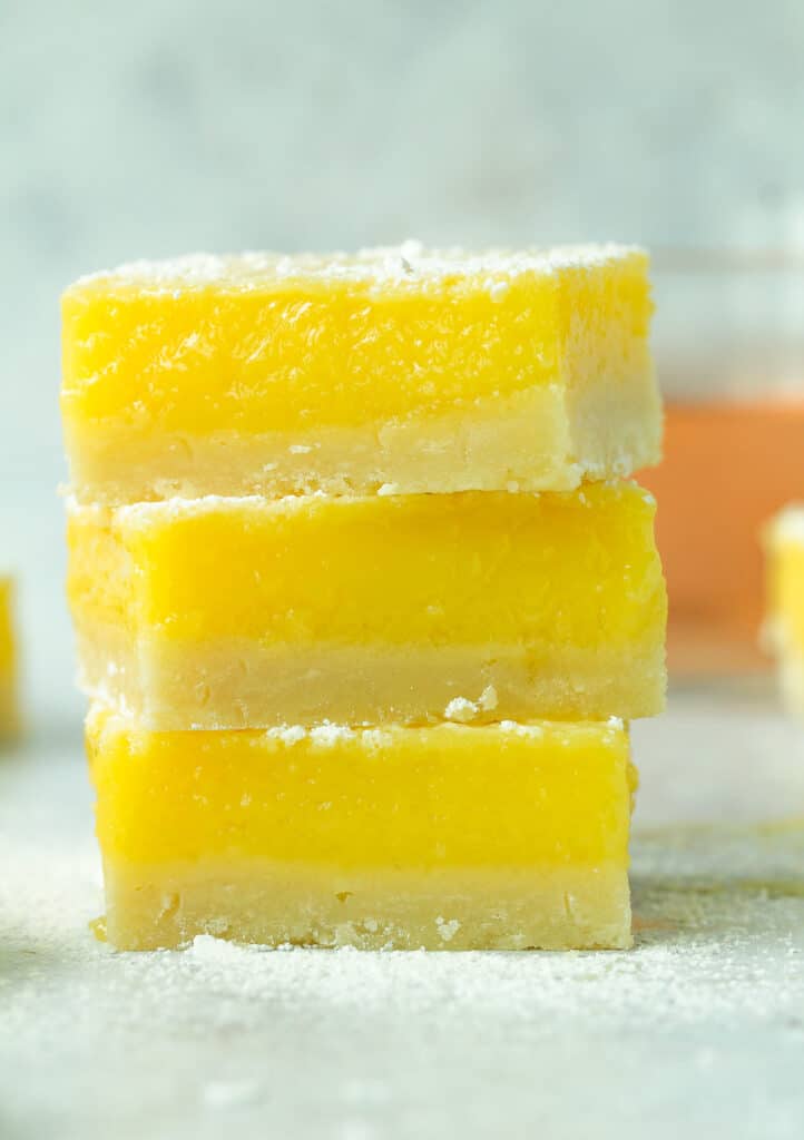 Stack of three lemon rosé bars with powdered sugar on top