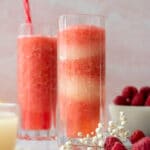 Two glass of raspberry limoncello frosé with flowers and raspberries