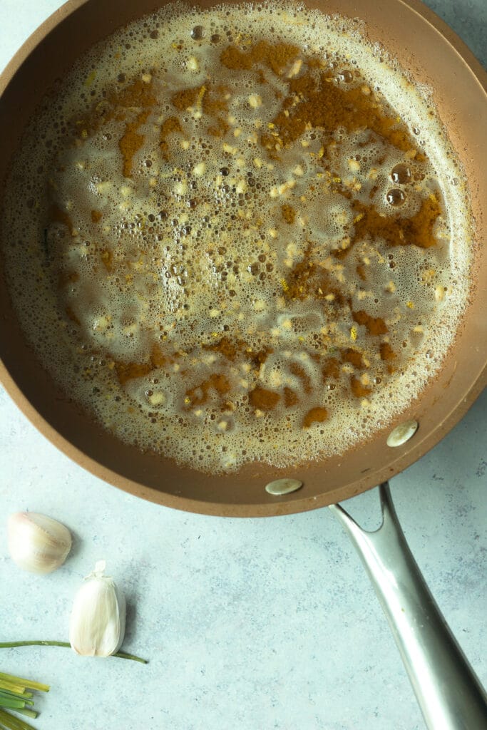 melted butter in pan with minced garlic and lemon zest