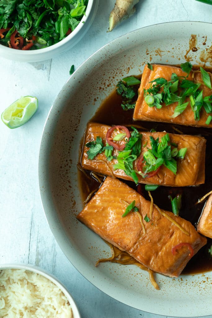 rosé caramel salmon filets in pan with side of rice