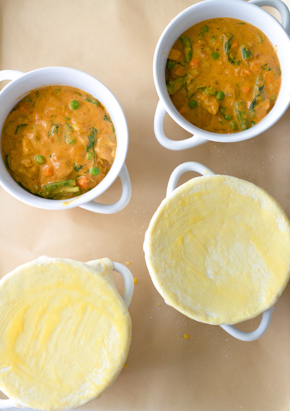 Four mini pot pies ready for oven.