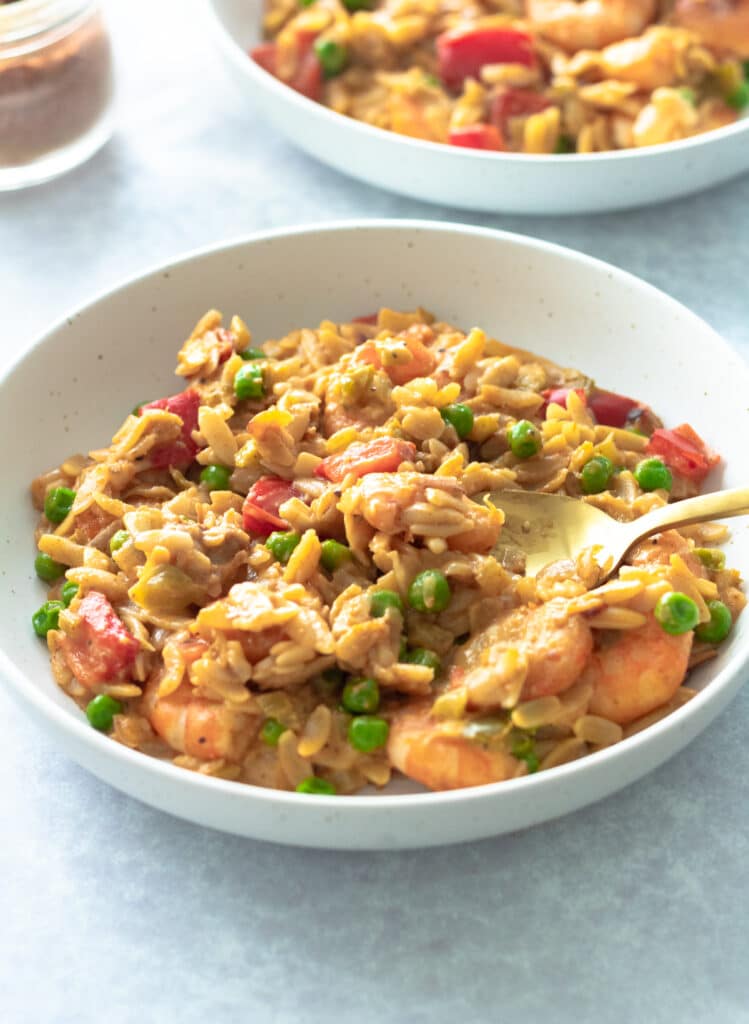 bowl of orzo with shrimp with spoon