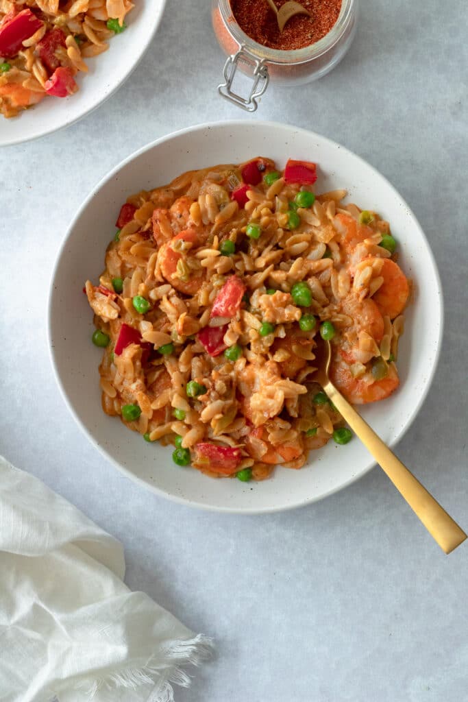 bowl of creamy orzo with cajun shrimp