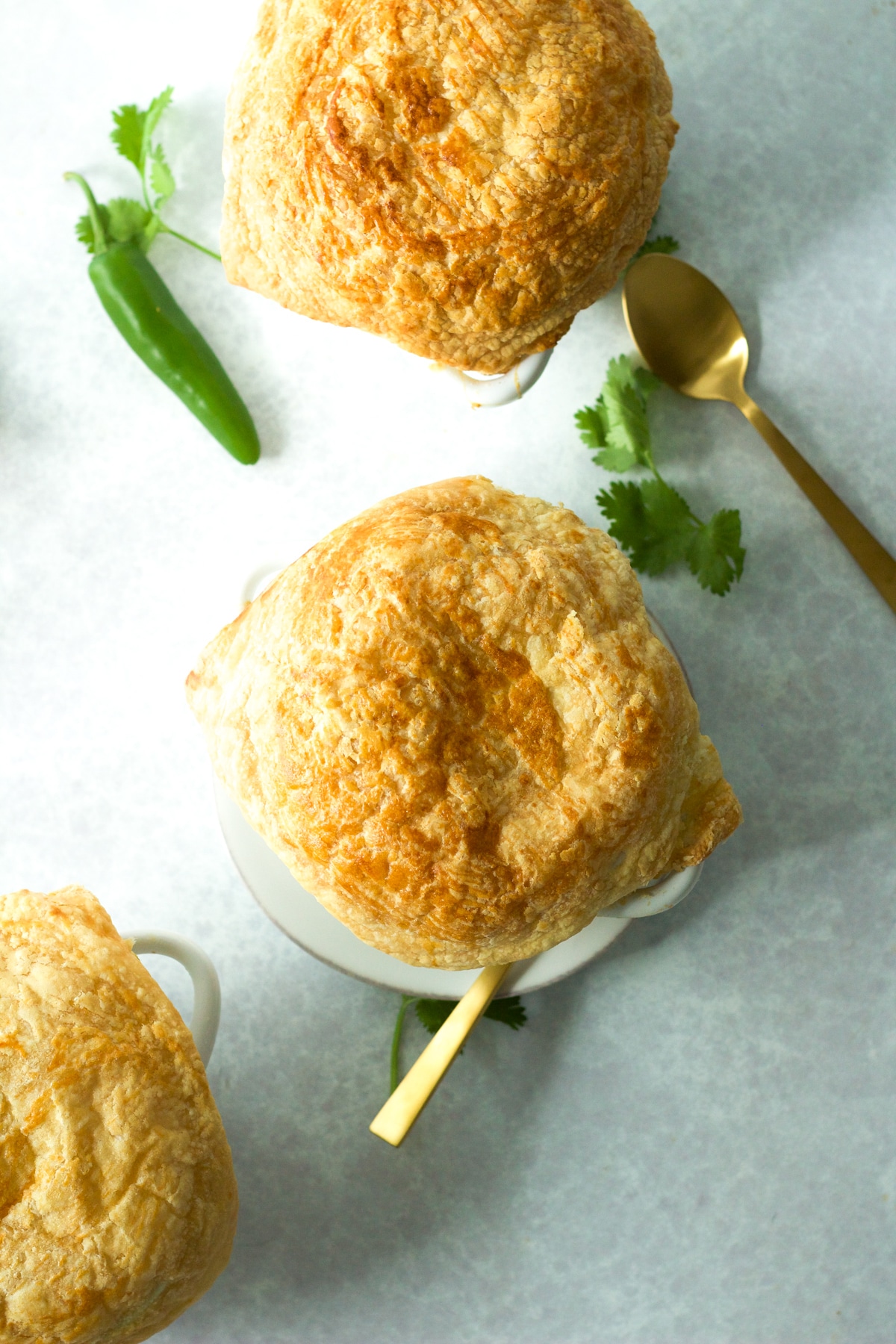 Three curry chicken pot pies on board.