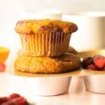 2 cranberry sauce muffins stacked in pan with coffee cups on table