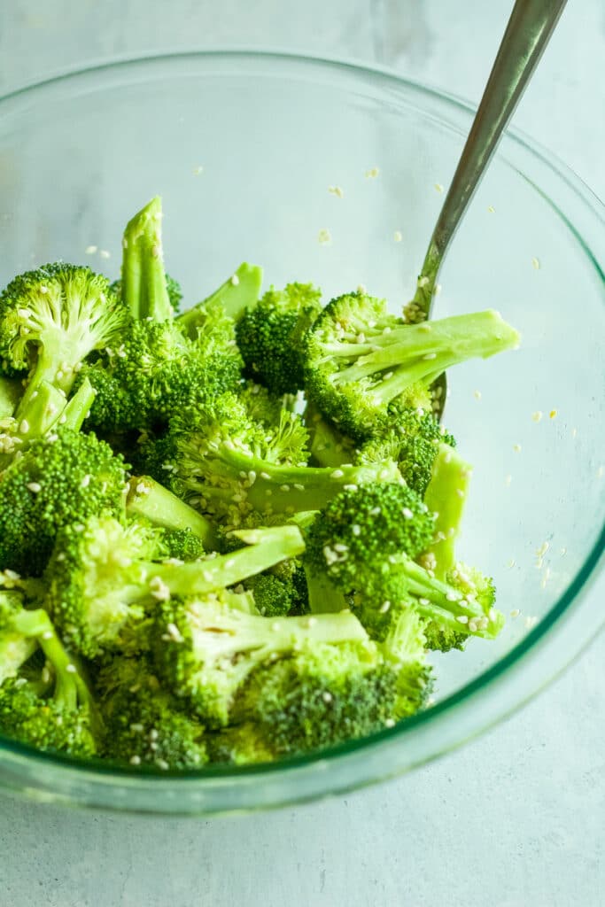broccoli cut up in bowl with seasonings