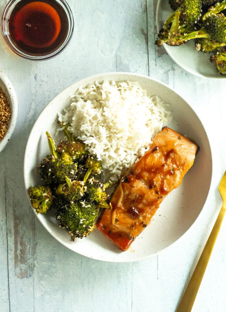 roasted maple sesame broccoli on plate with rice and salmon