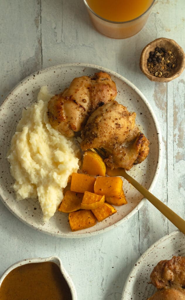 plate with apple cider chicken and roasted butternut squash