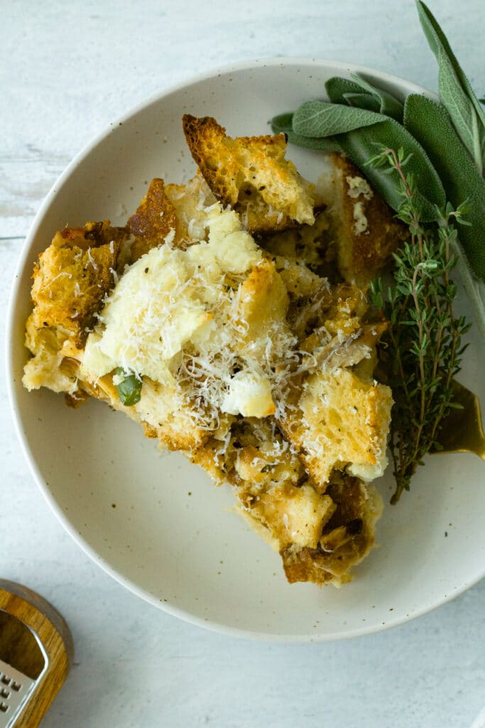 top of thanksgiving strata on plate with herb garnish