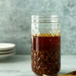 garlic chili oil in glass jar with cinnamon stick and star anise