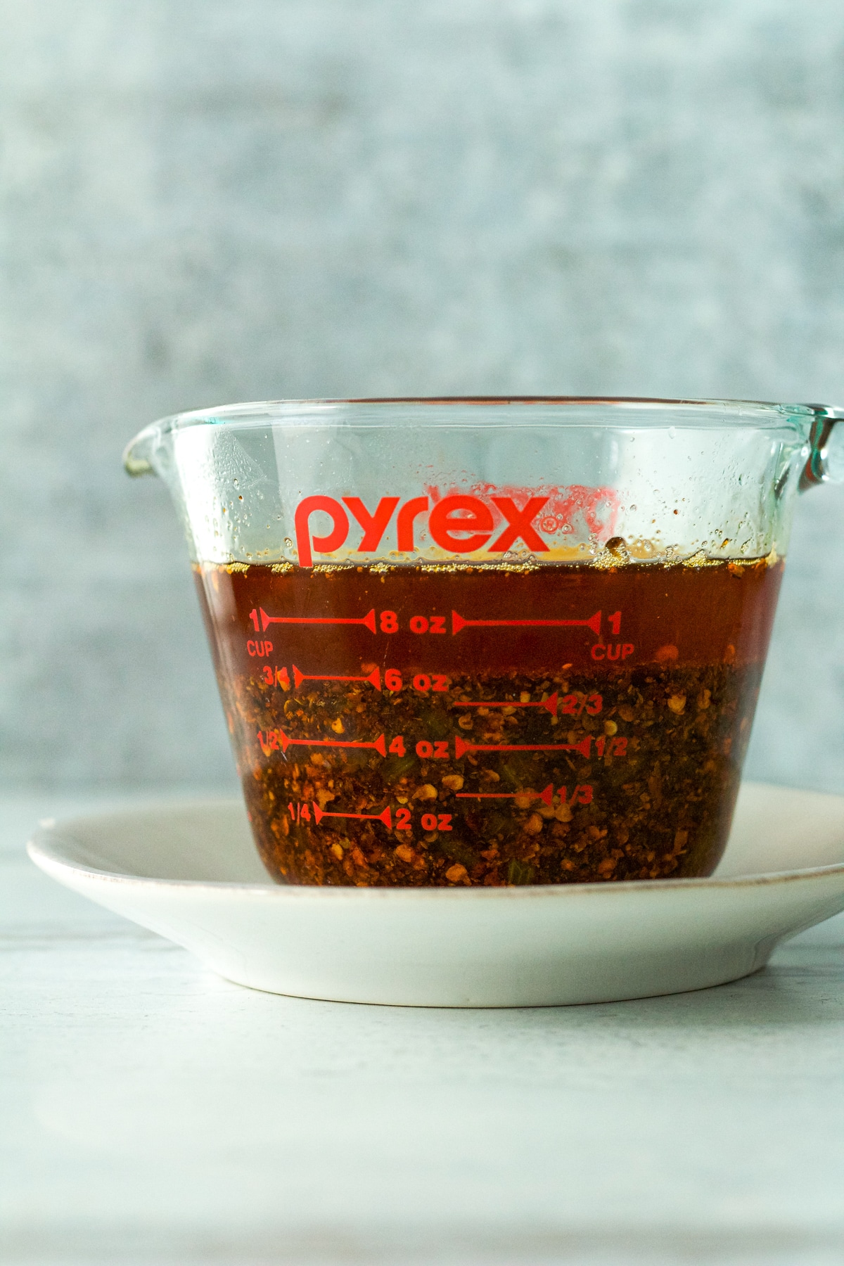 chili oil in glass measuring cup.