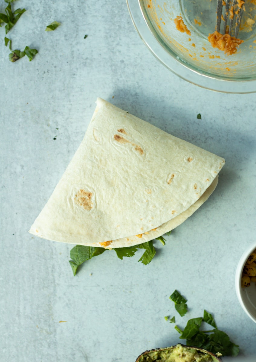 Final fold of buffalo chickpea wrap.