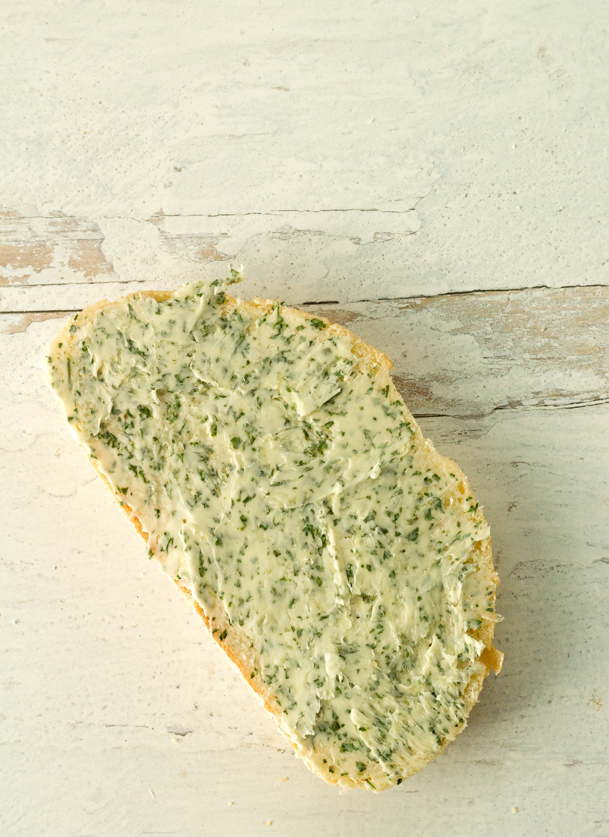 Bread with garlic butter before baking.