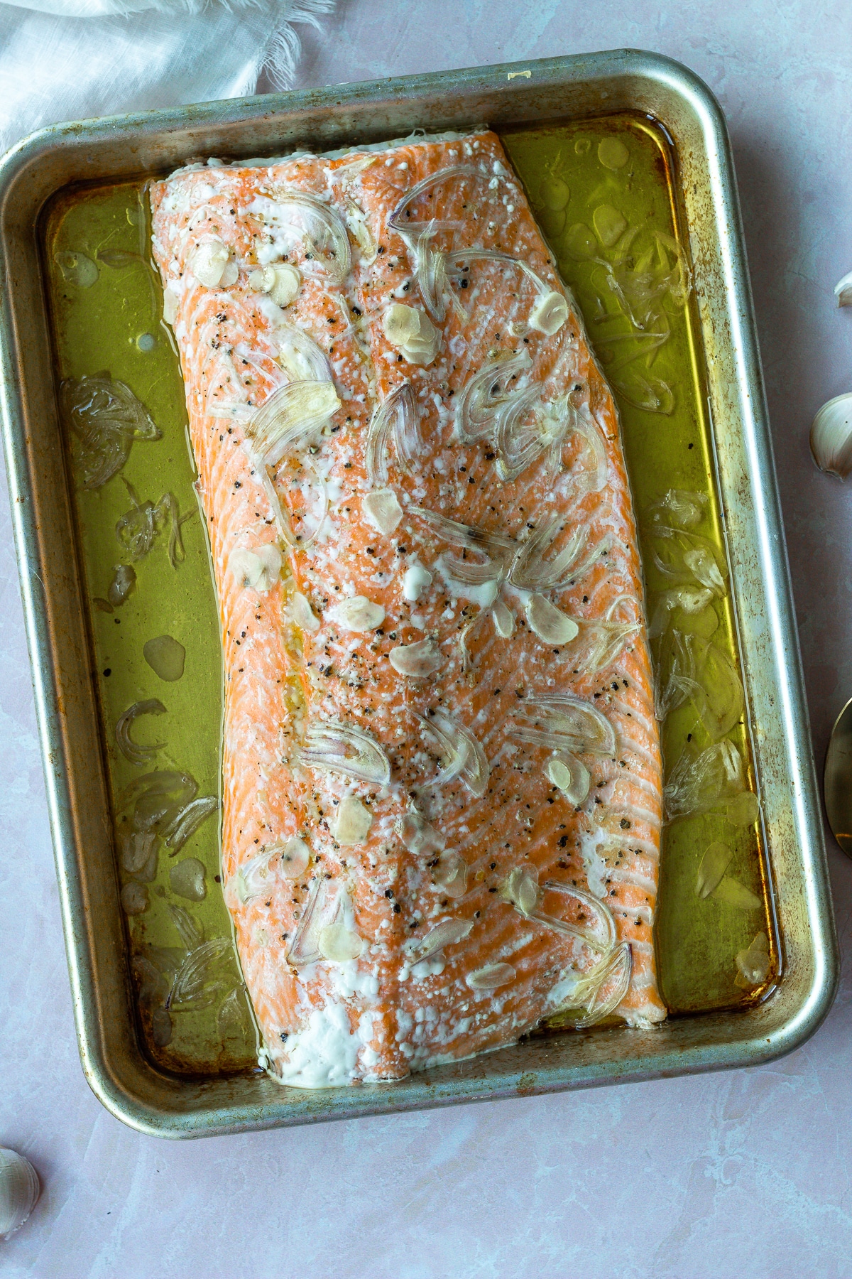 Slow baked salmon on baking sheet.
