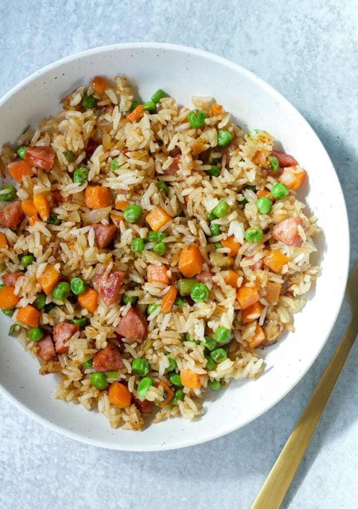 Dish with fried rice and fork on side.