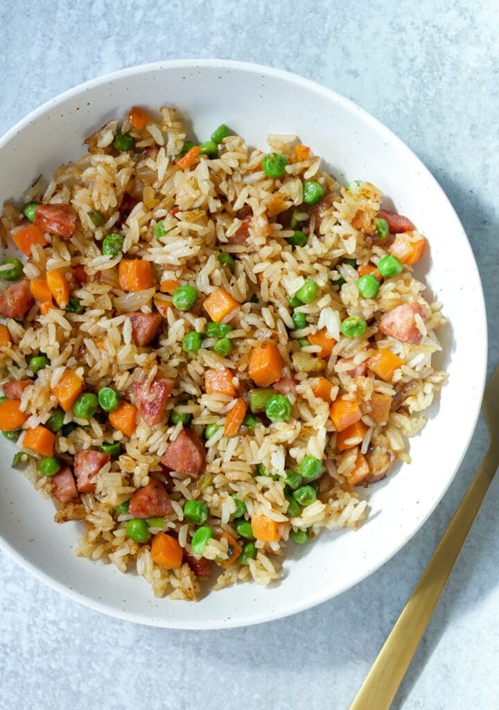 Dish with fried rice and fork on side.
