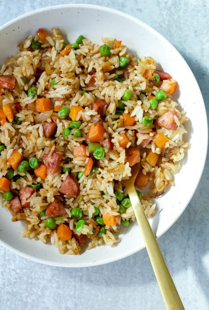 Fried rice on plate with gold fork.