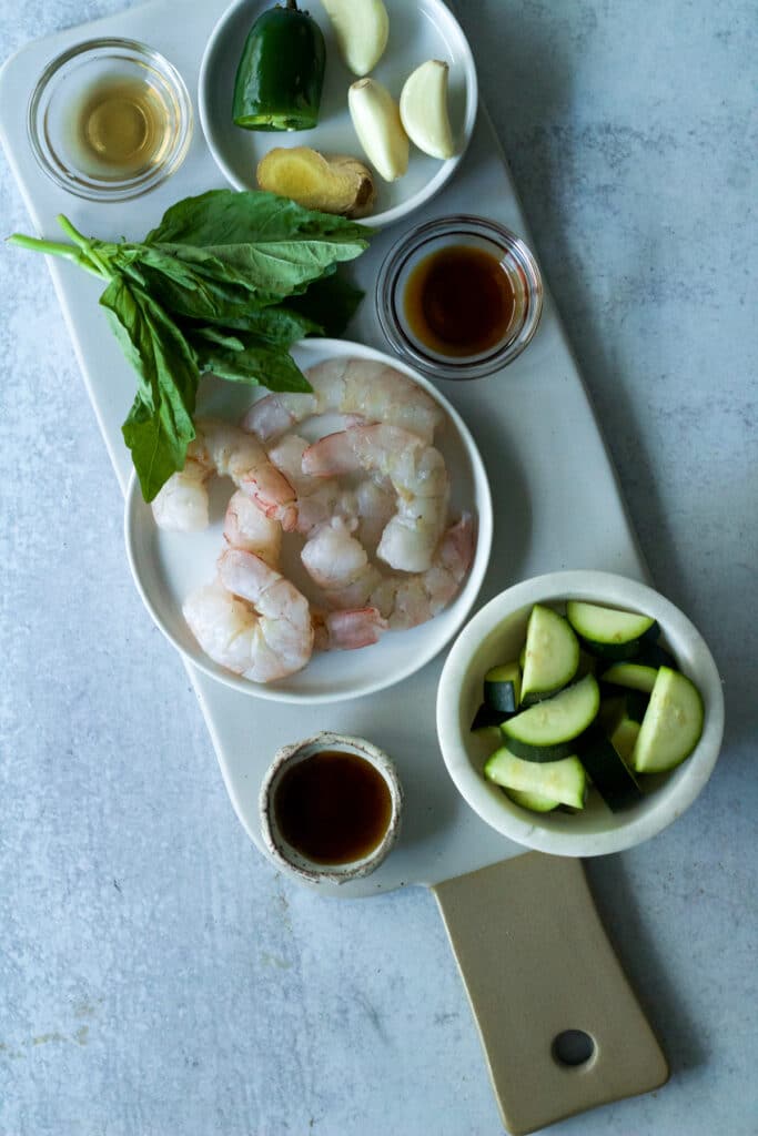 Ingredients for shrimp and basil stir fry on board.
