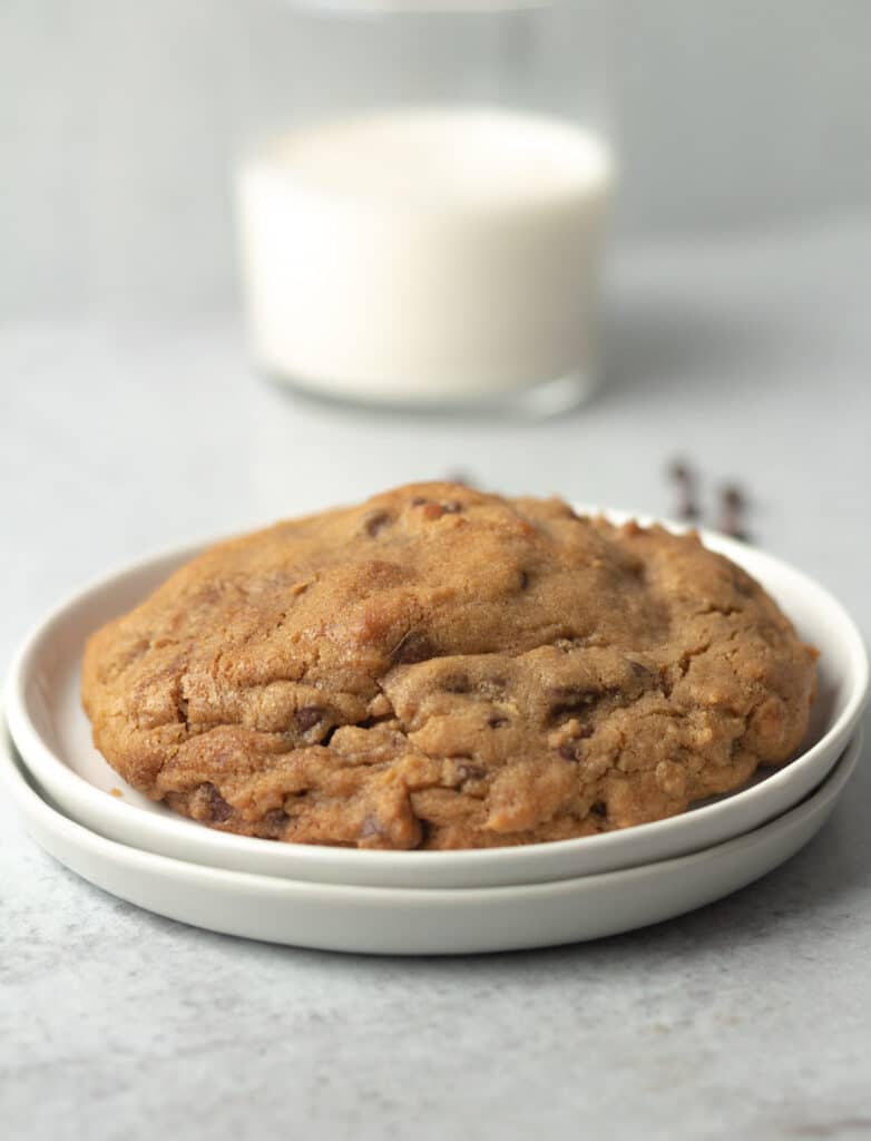 Levain bakery copycat cookie on plate with milk.