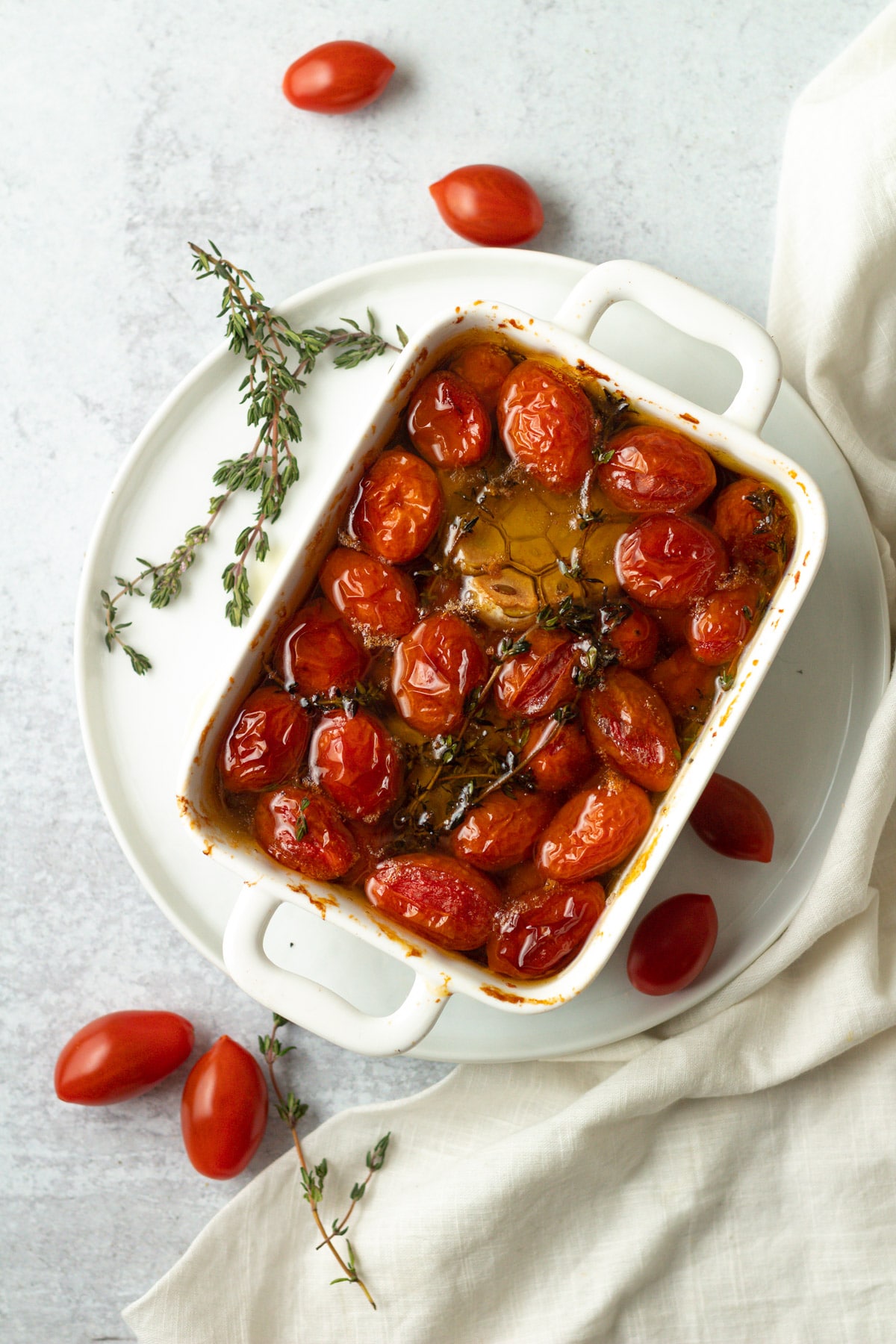 Baking dish with cherry tomato confit on plate.