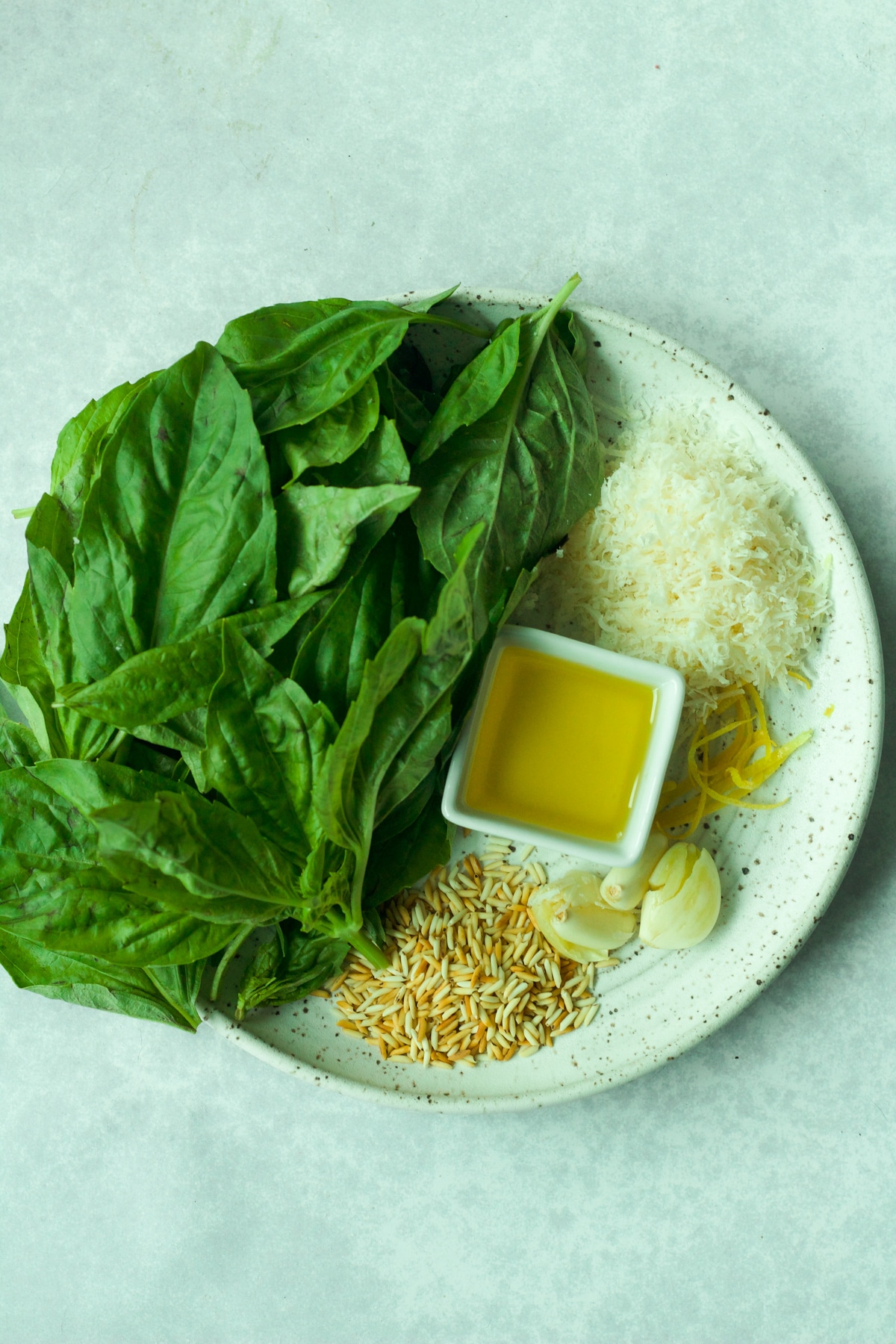 Ingredients to make pesto without nuts on plate.