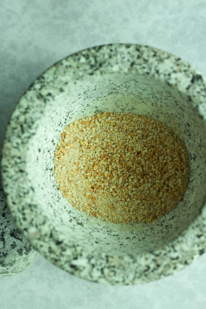 Toasted rice powder in mortar and pestle.