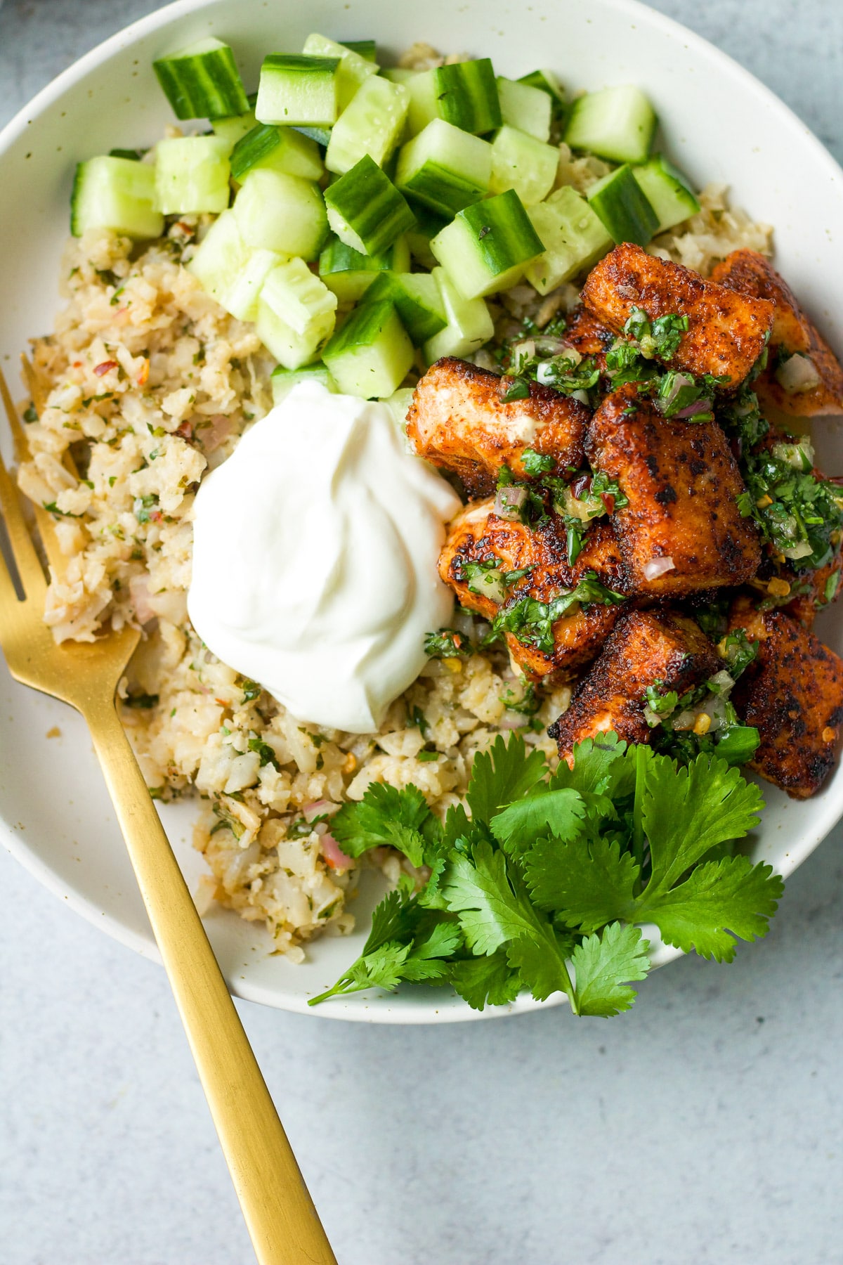 Overhead shot of salmon grain bowl with fork.