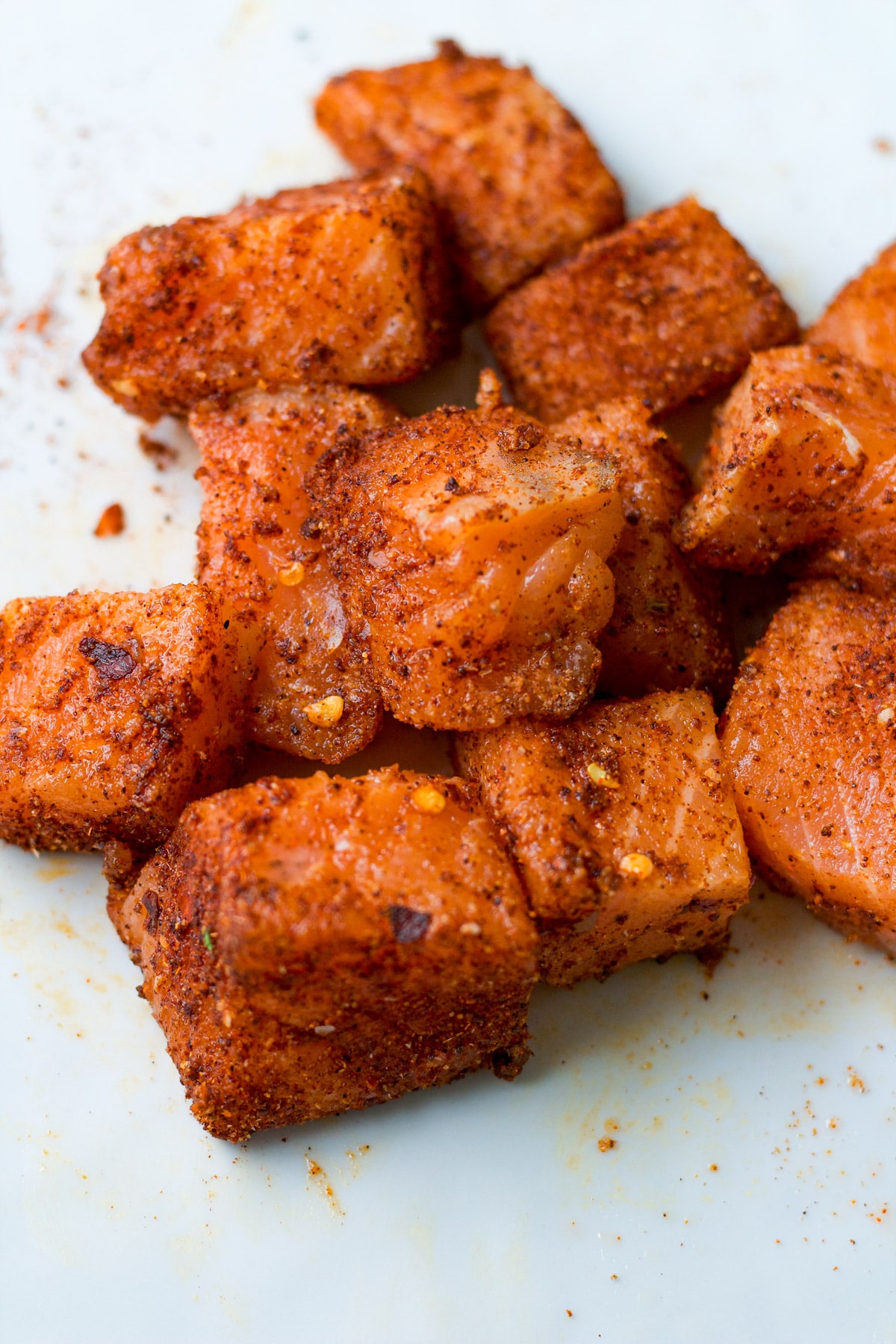 Raw salmon nuggets with spices.