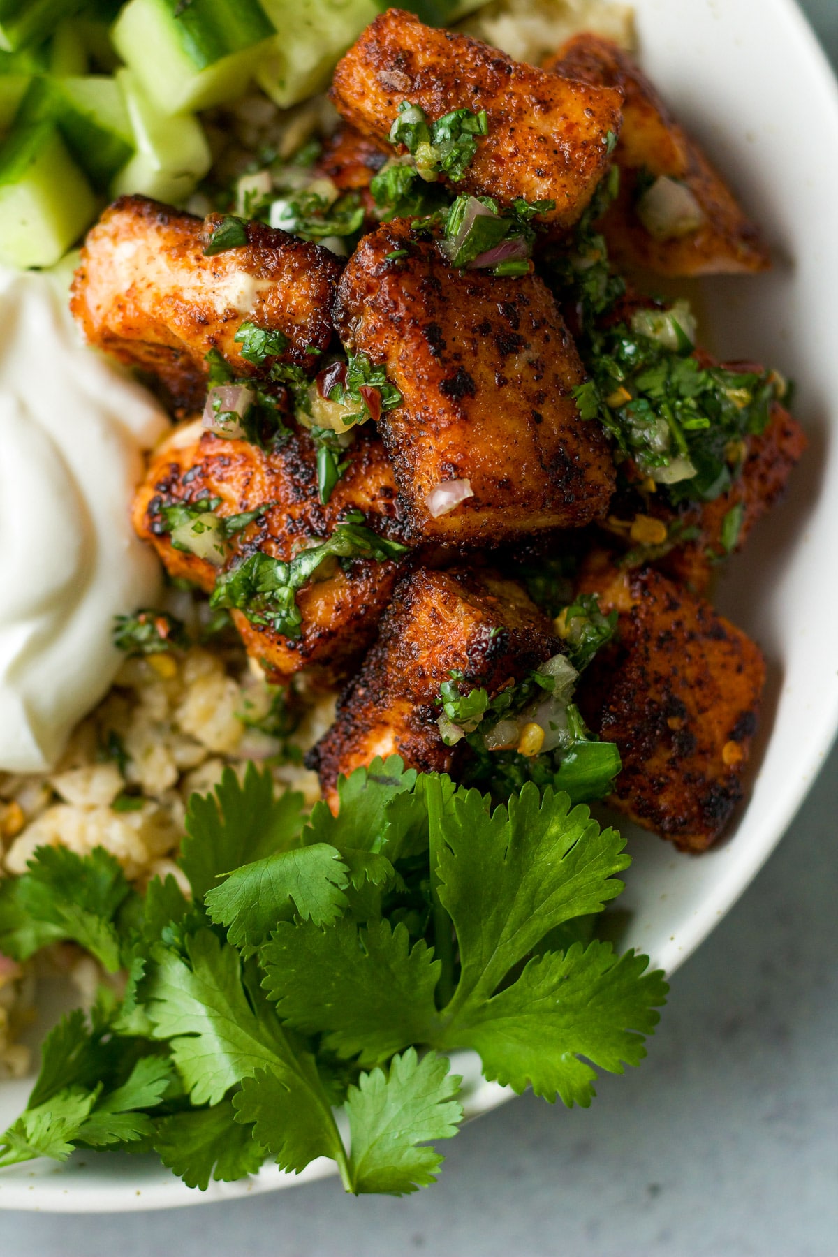 Cilantro chimichurri on spiced salmon bowl.