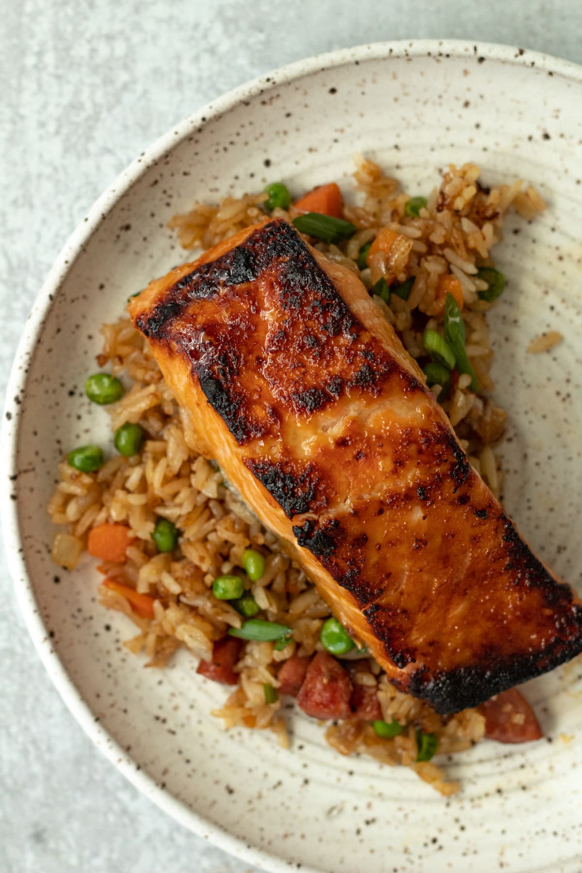 Salmon filet with miso-honey on bed of fried rice.