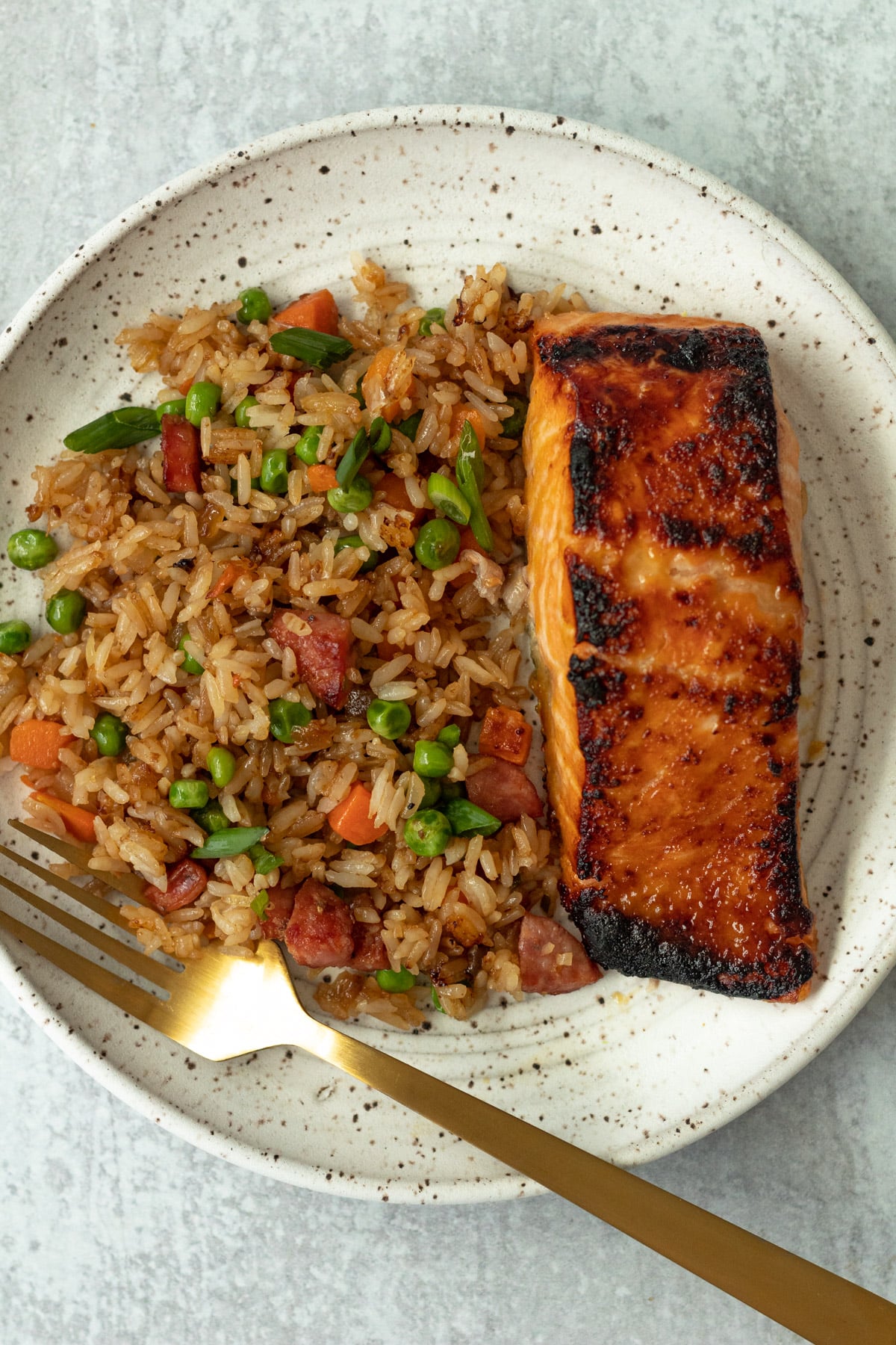 Plate with fried rice and broiled miso honey salmon for one.